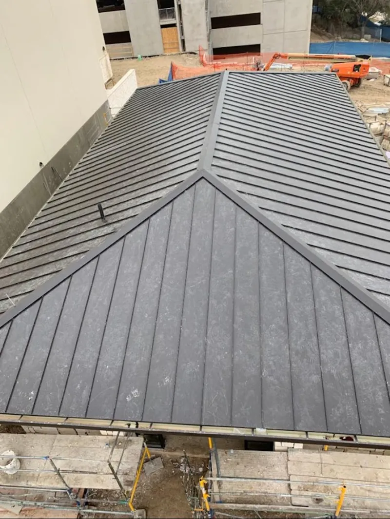 Commercial metal roof construction with crane equipment in Wickenburg